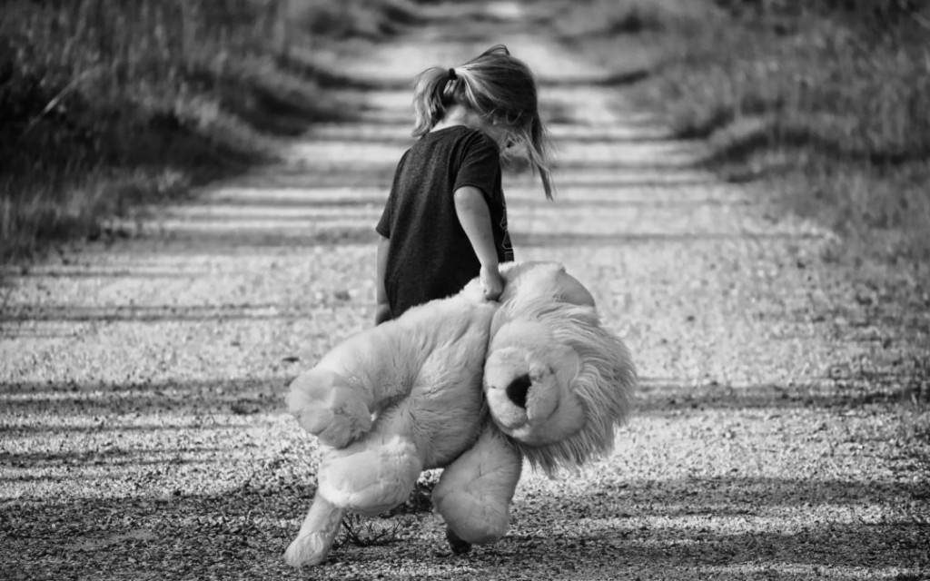 black-and-white-image-of-girl-carrying-teddy-bear-1080x675